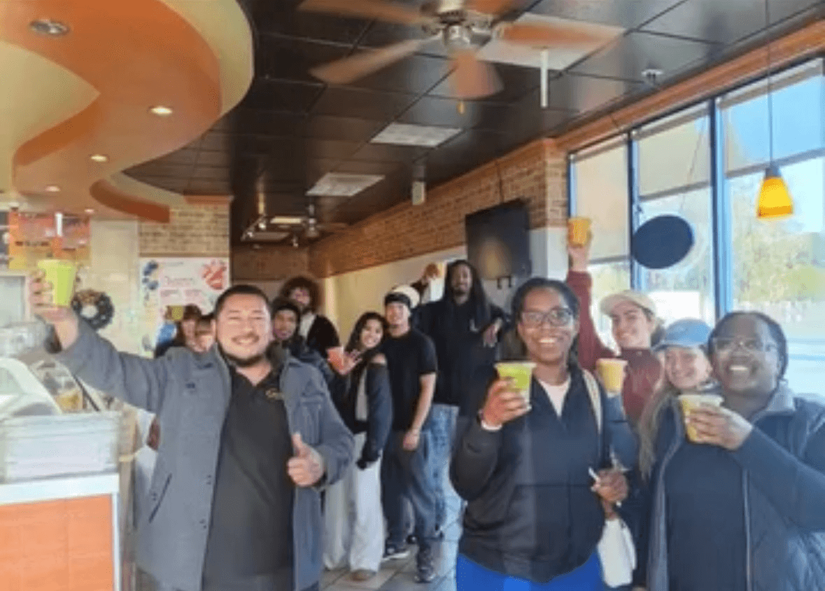Sunshine Smoothies supporters celebrating together inside the shop